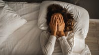 woman struggling to sleep in bed